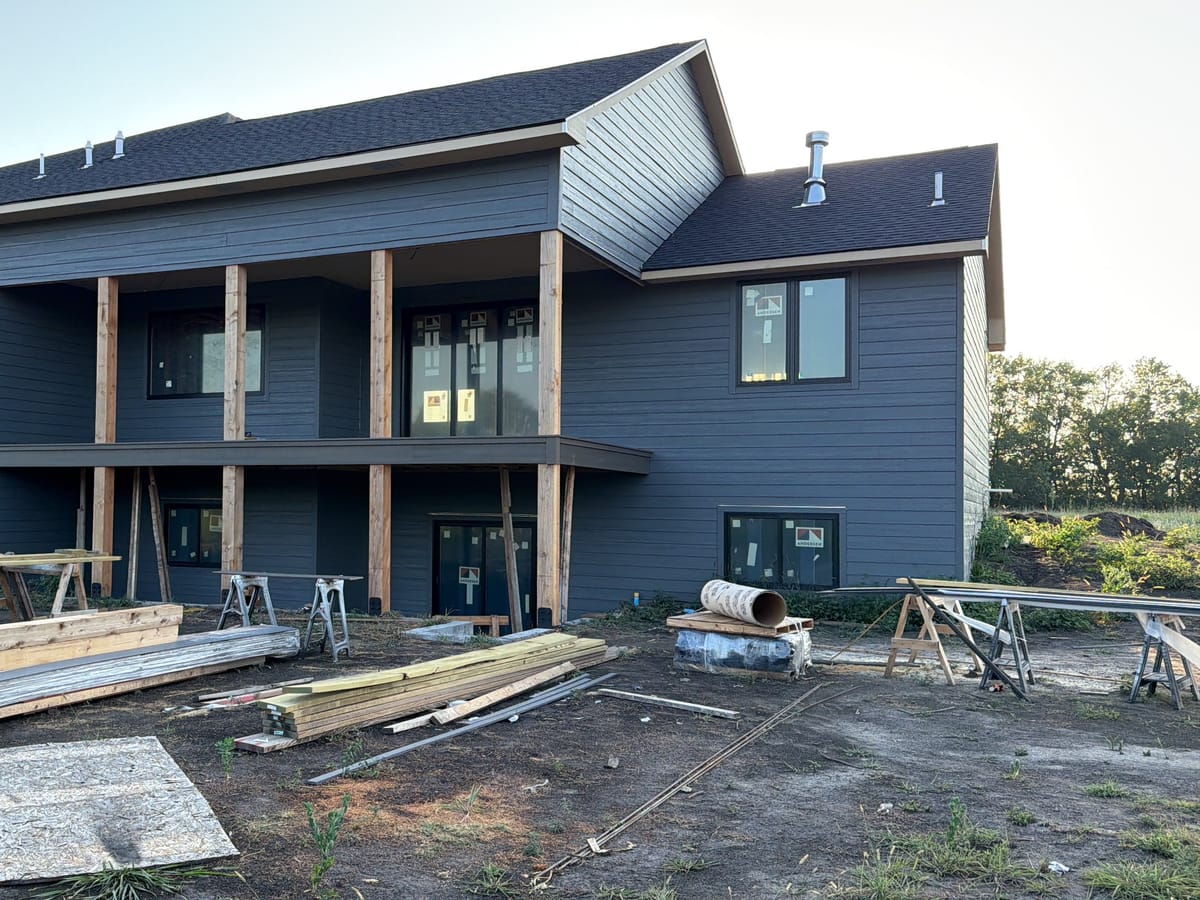 A custom home under construction by JAKS Construction, sided and roofed