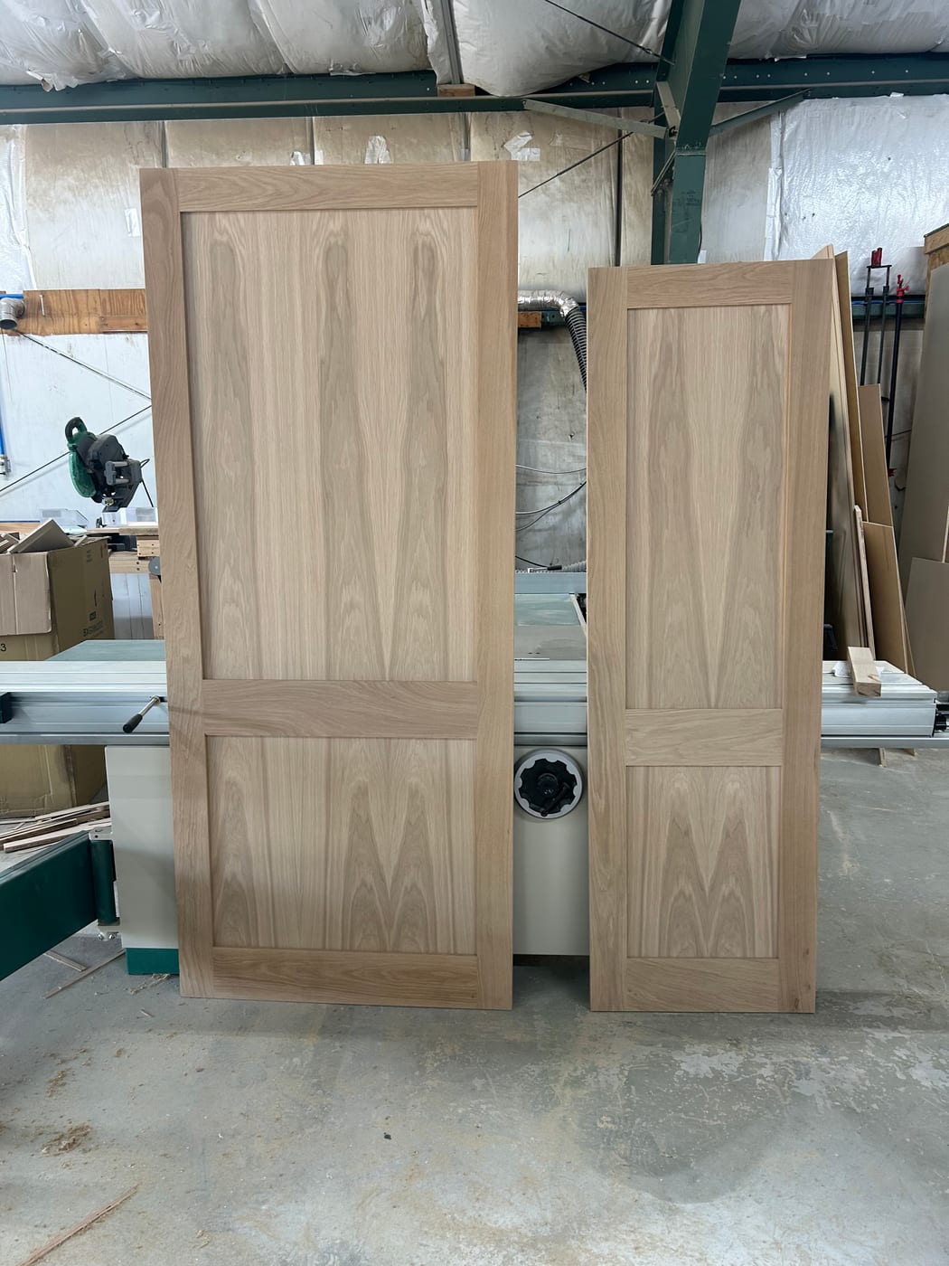 Raw white oak doors built in the JAKS millwork shop, waiting on finish
