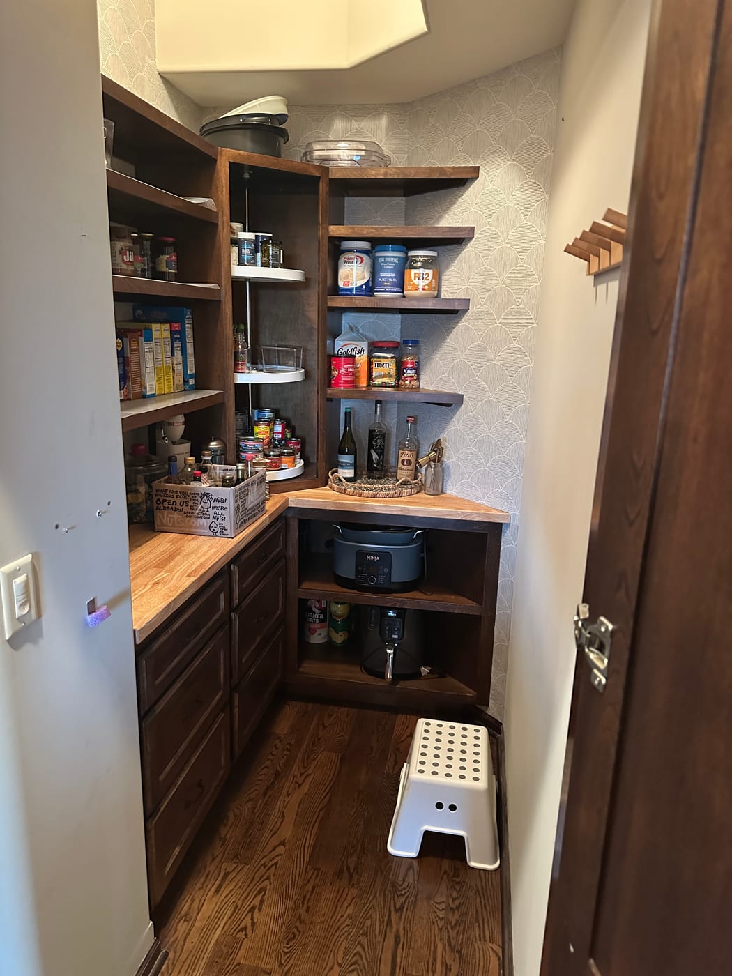 The finished walk-in pantry with butcher block counters and appliance storage in Andover, Kansas